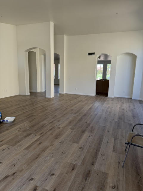 AZ1 Builders PebbleCreek project interior with wood-look plank flooring, light-colored walls and arched openings
