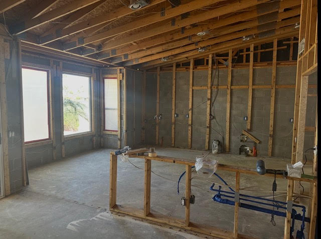 Construction-stage interior at an AZ1 Builders project in PebbleCreek, Goodyear, with exposed wall framing and ceiling joists
